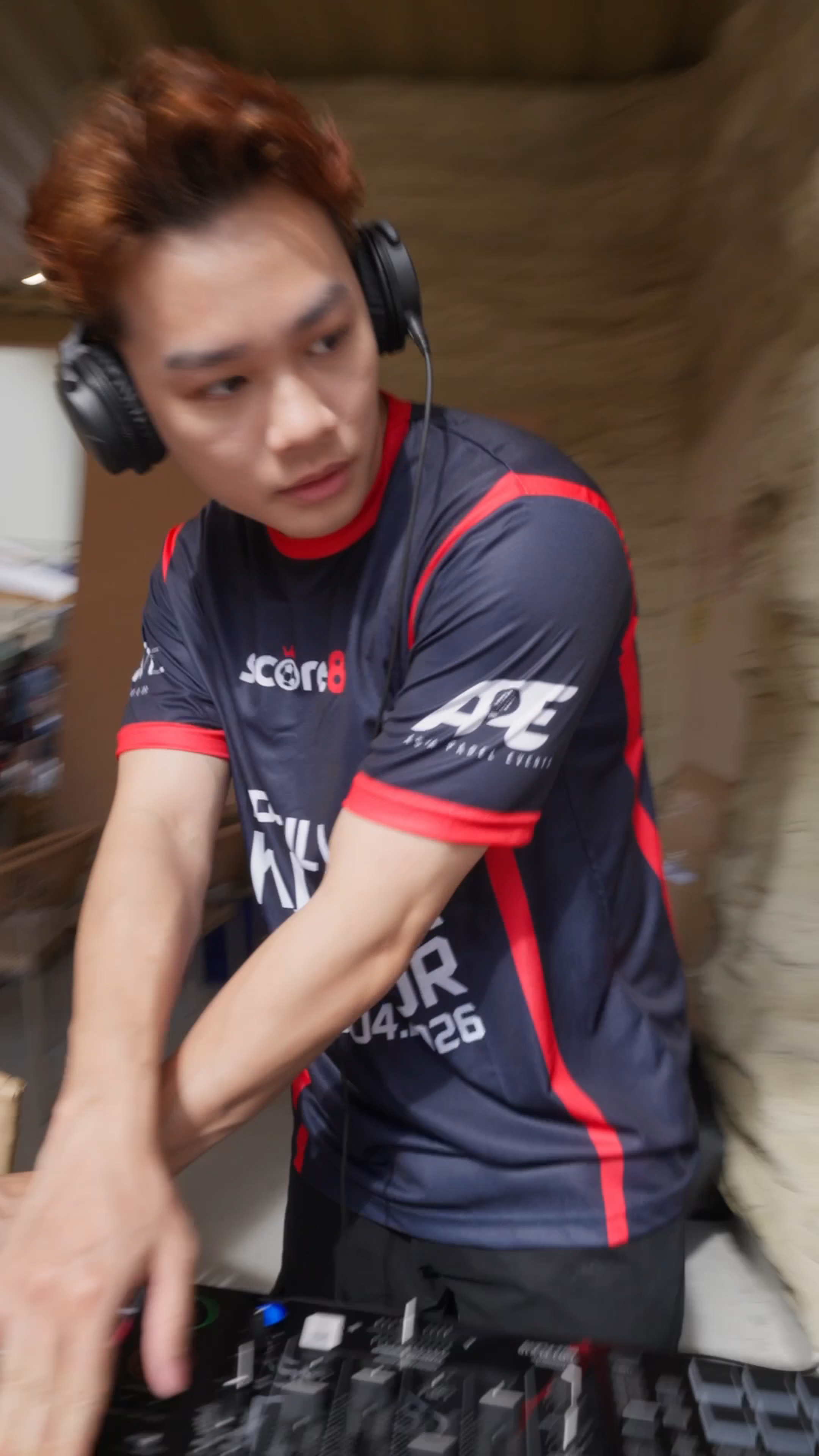 DJ performing beside Score8 branding