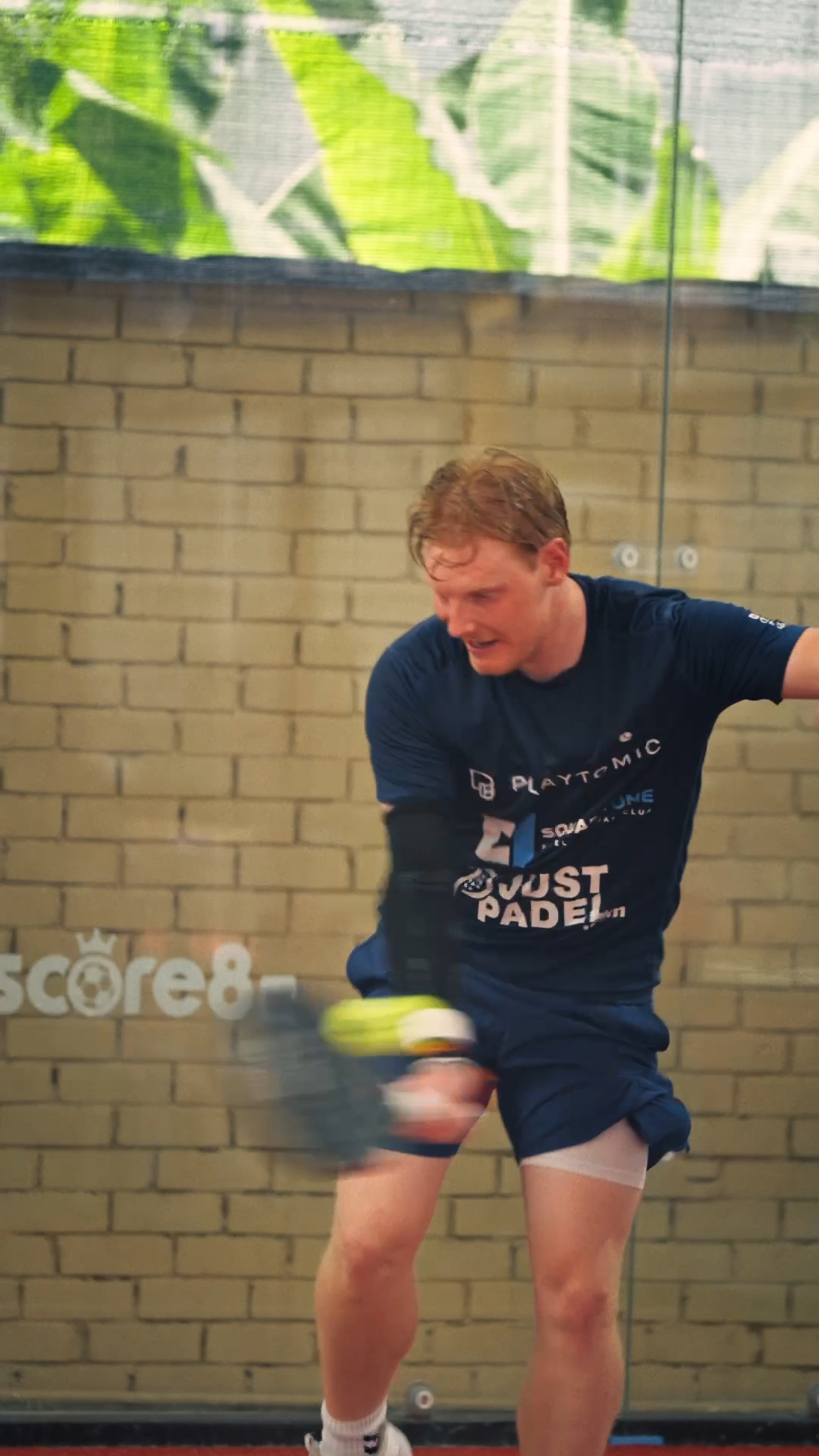 Padel player competing beside Score8 branding at FIP Silver Kuala Lumpur